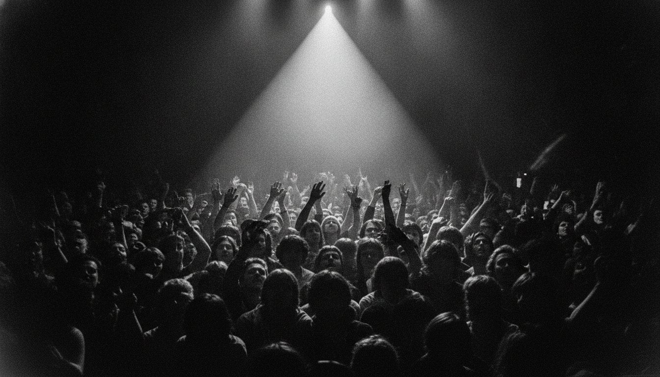 Crowd under stage light, faces upturned